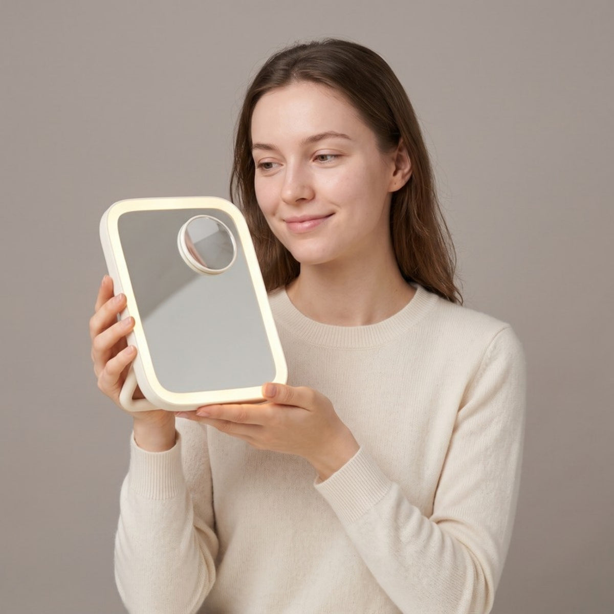 Model holding the Lumi Lighted Vanity Mirror