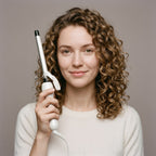 Model holding the Twirl Mini Curling Iron