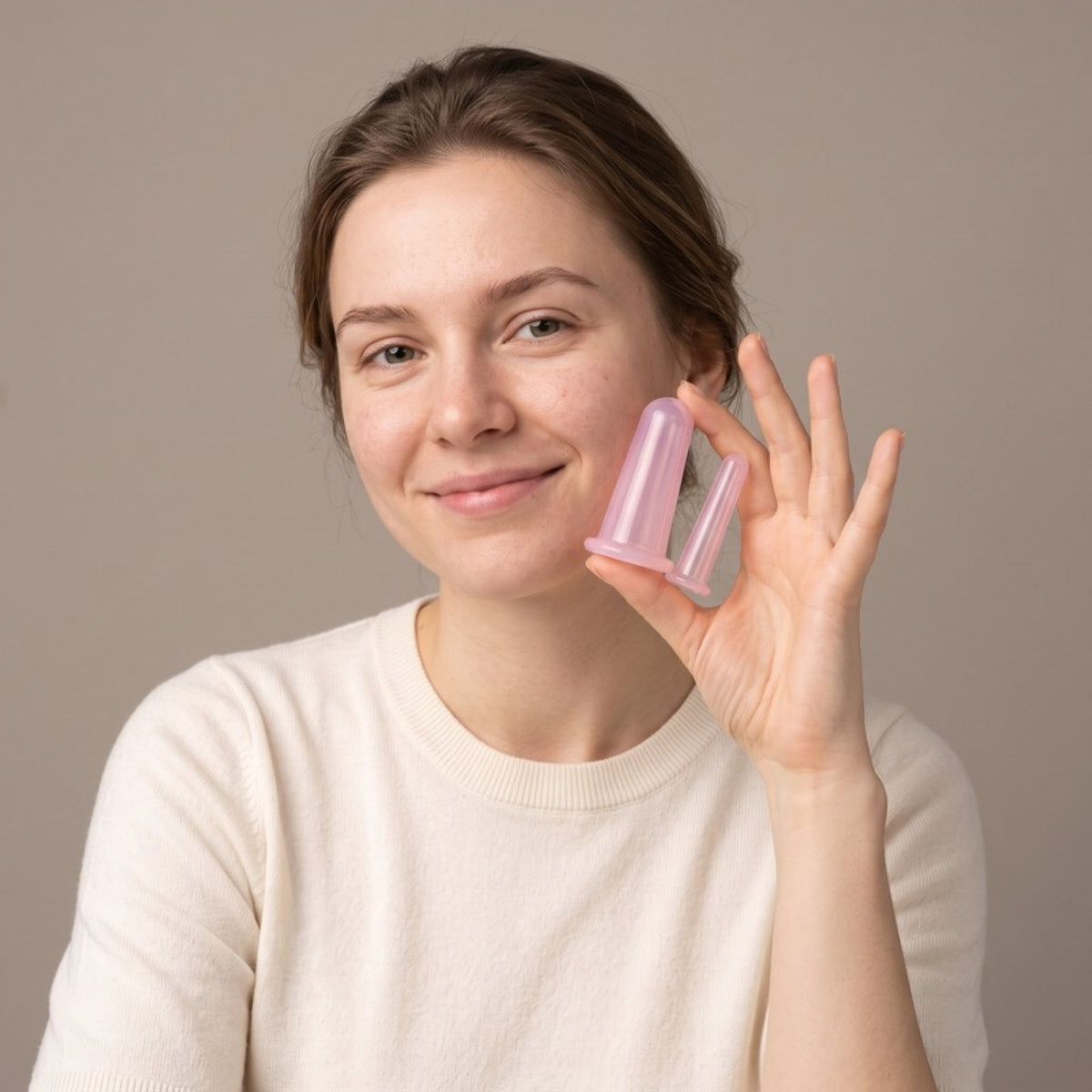 Model holding the Sculpt Facial Cupping Set