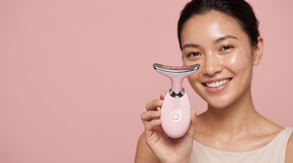 Woman holding the Asetics Contour EMS face and neck massager
